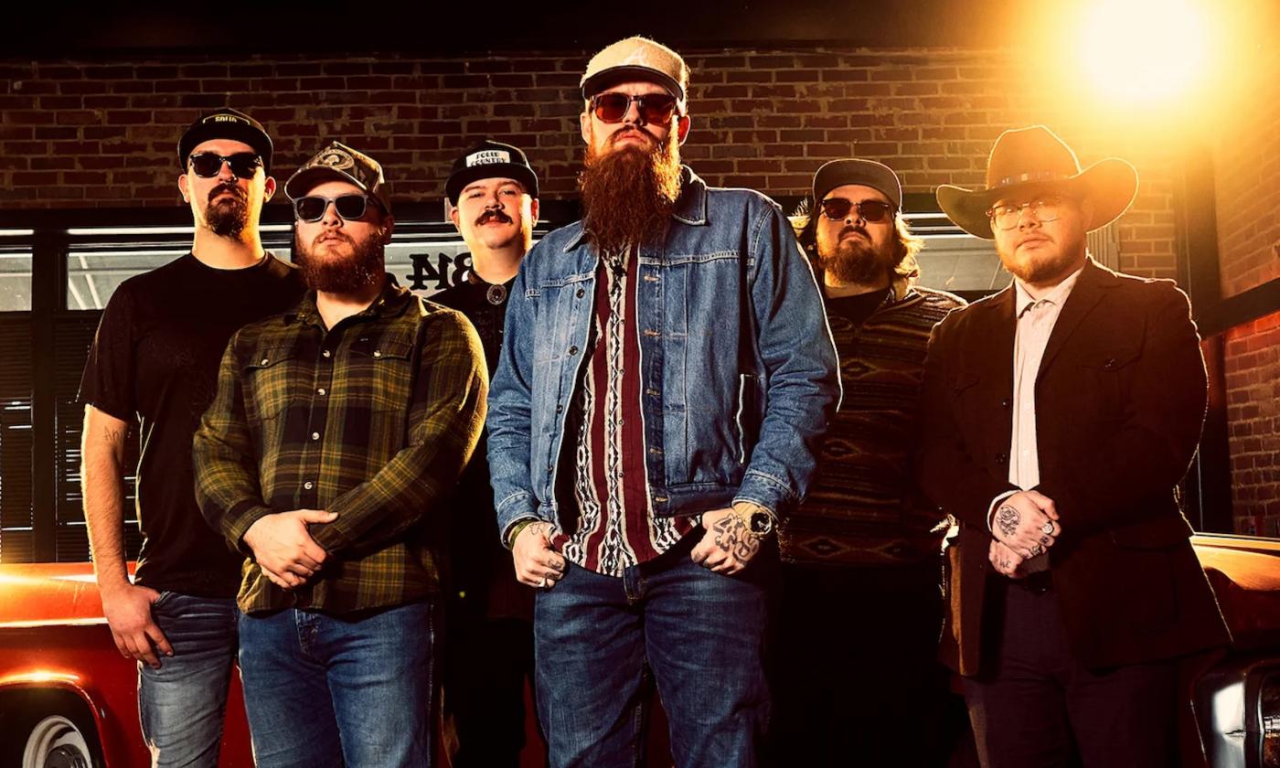 Bandmates from 49 Winchester pose in hats and dark sunglasses.