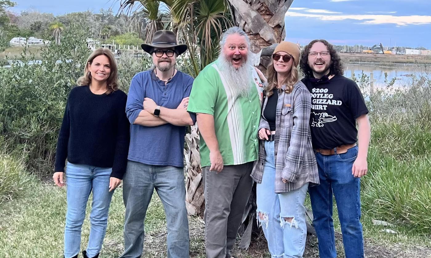 The five members of the band Dead Parrots Society standing outside in St. Augustine near the San Sebastian River