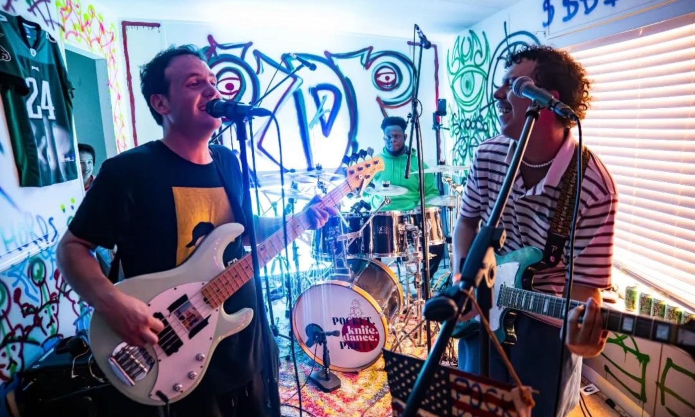 Bandmates from Pocket Knife Dance Party perform at a venue.