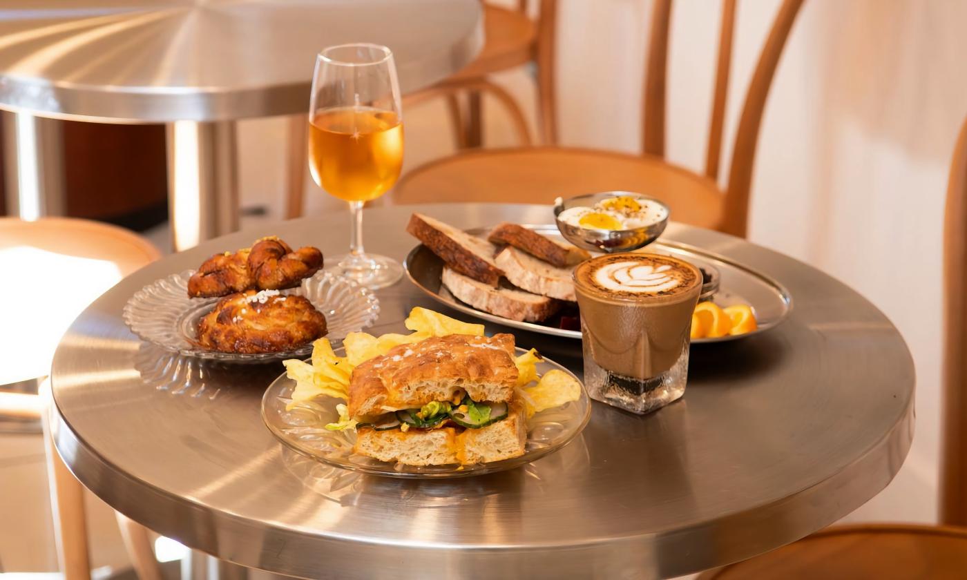 Coffee, wine, pastries, and additional fare on the table