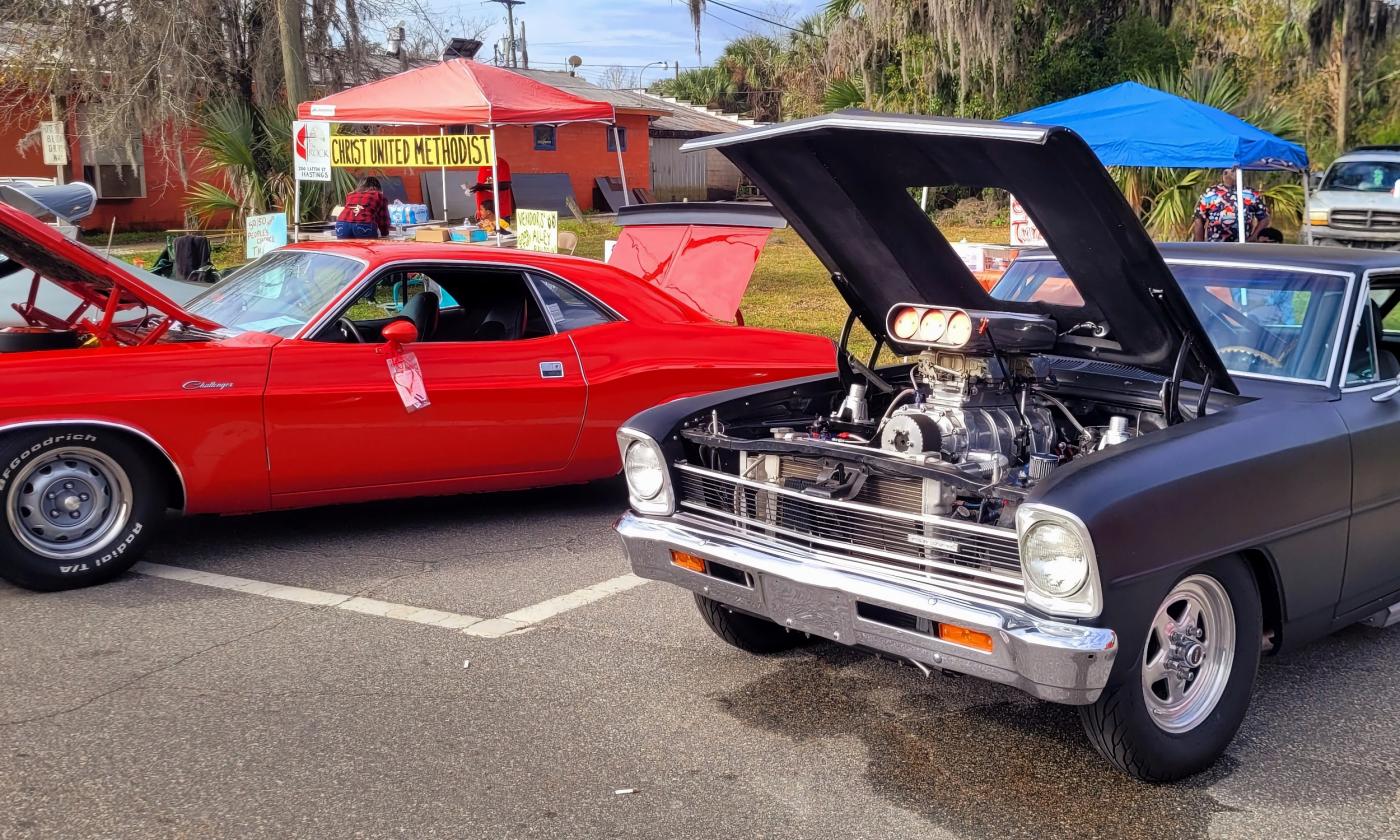 A line of cars with the hood up