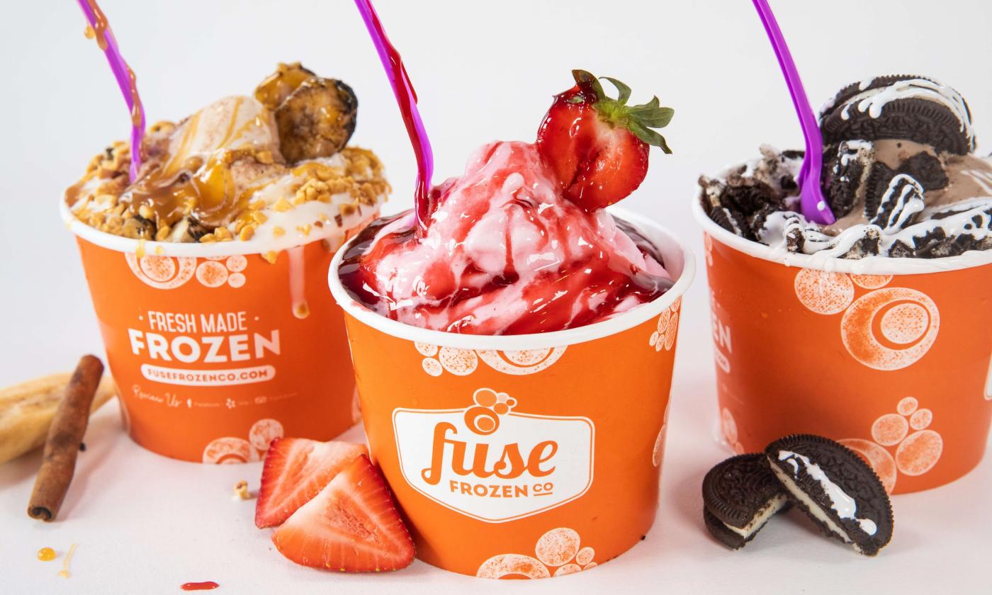 Cups filled with frozen yogurt and toppings