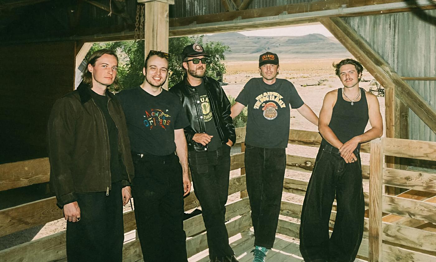 The five members of the Crooked Kings standing in a barn