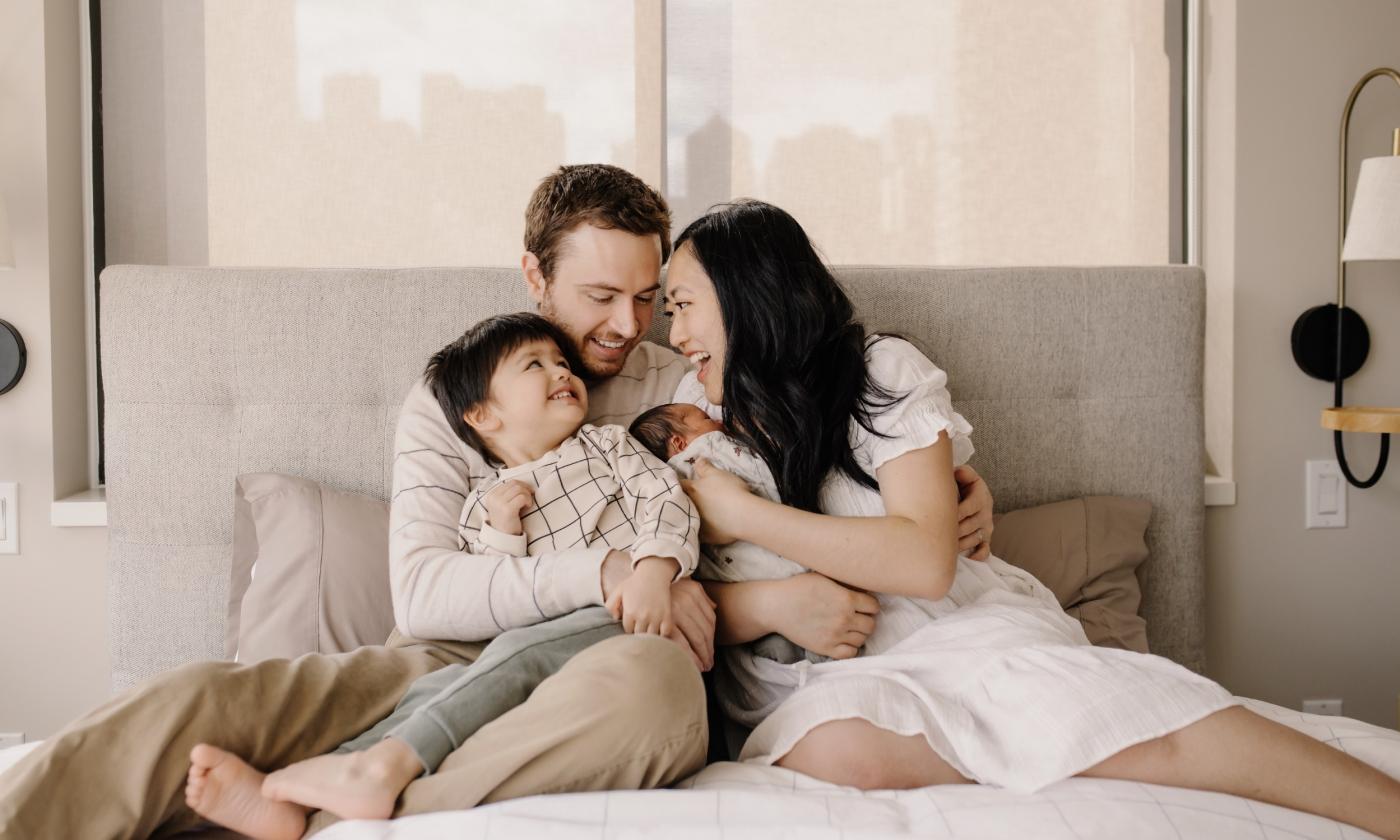 A family of three laughing together