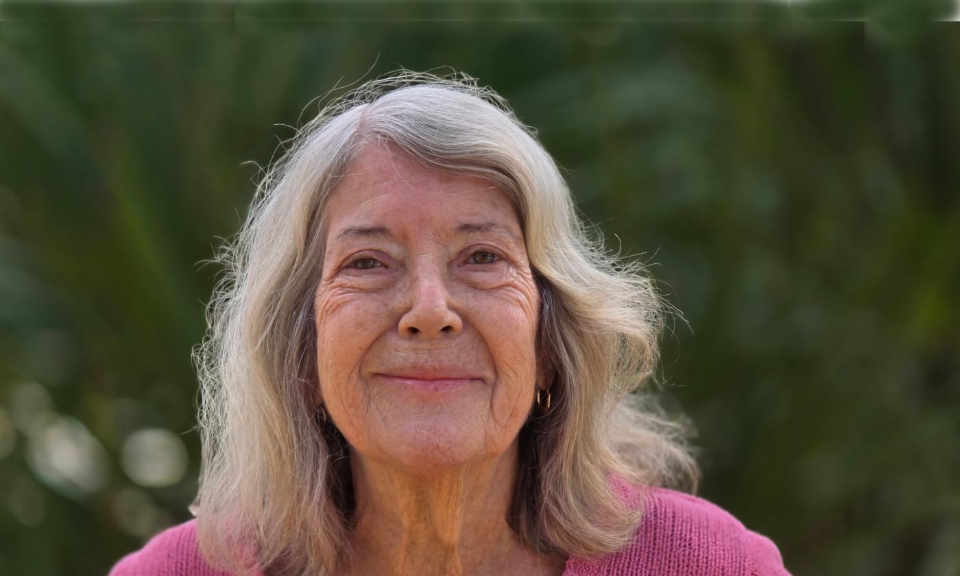 A woman in front of greenery on a sping day