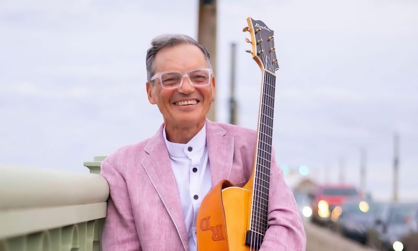 Russ DeFilippis with his guitar on the Bridge of Lions 