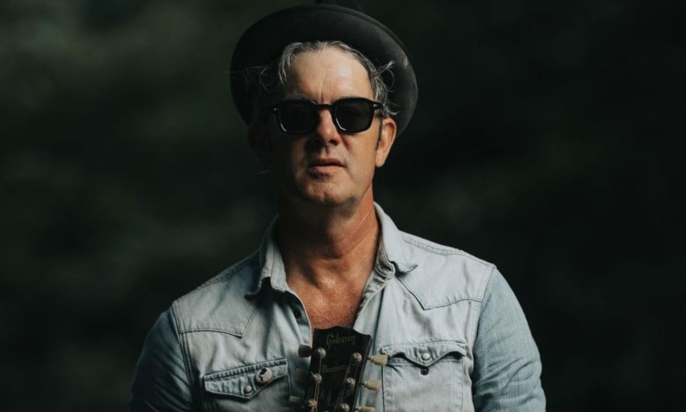 G Love poses with his guitar.