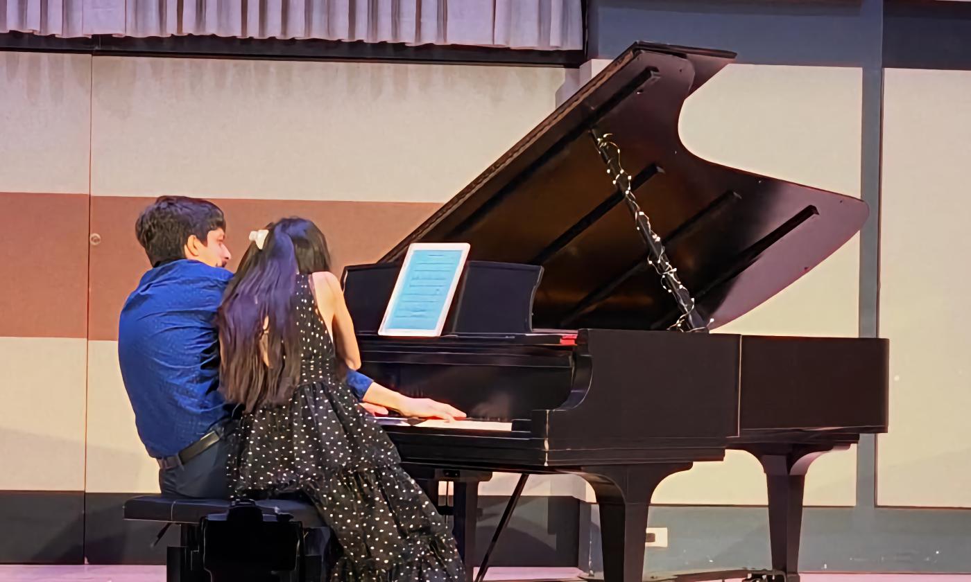 Echo Piano Duo performing on one piano in a four-hand compostion