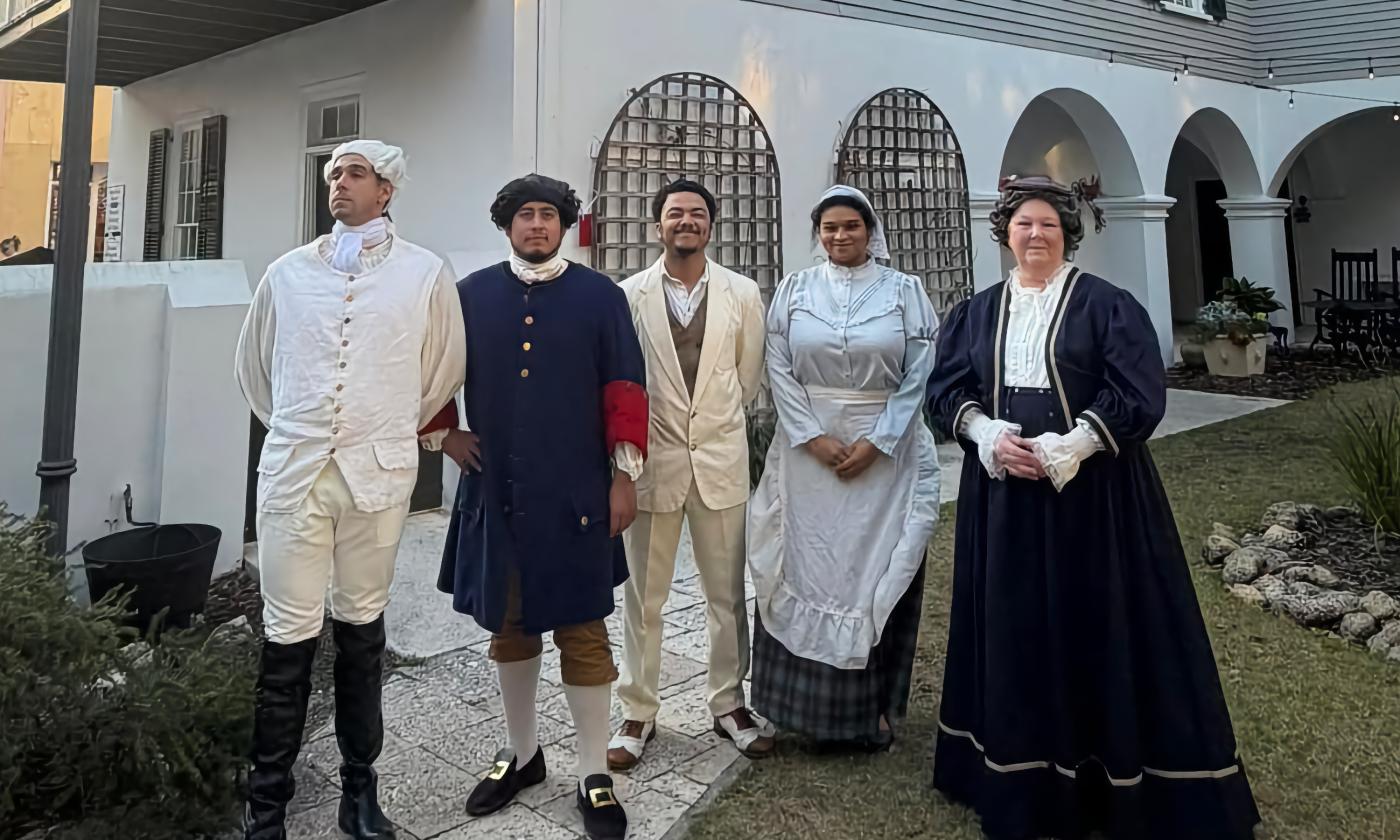 Five actors in historic dress outide the Peña-Peck House in St. Augustine