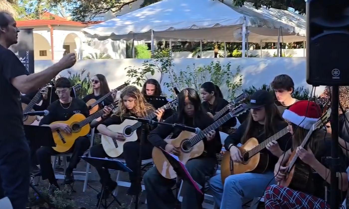 Young guitarists performing in a classical guitar ensemble