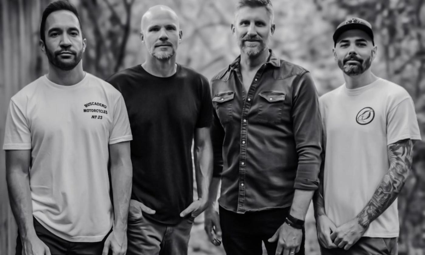 Bandmates from Exhaustra pose in a black and white photograph.