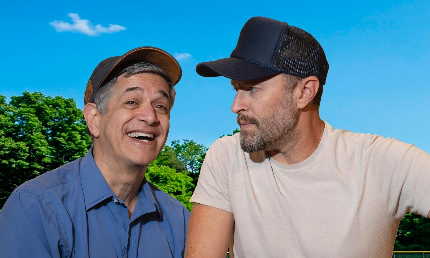 Two men with ball caps outside on a sunny day