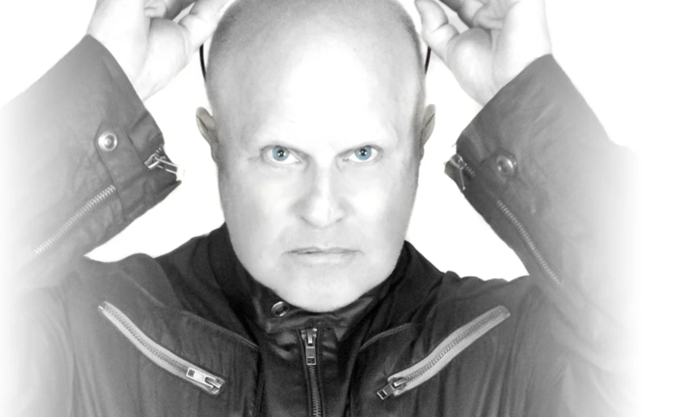 Lead bandmate for A Flock of Seagulls poses in a black-and-white photograph.