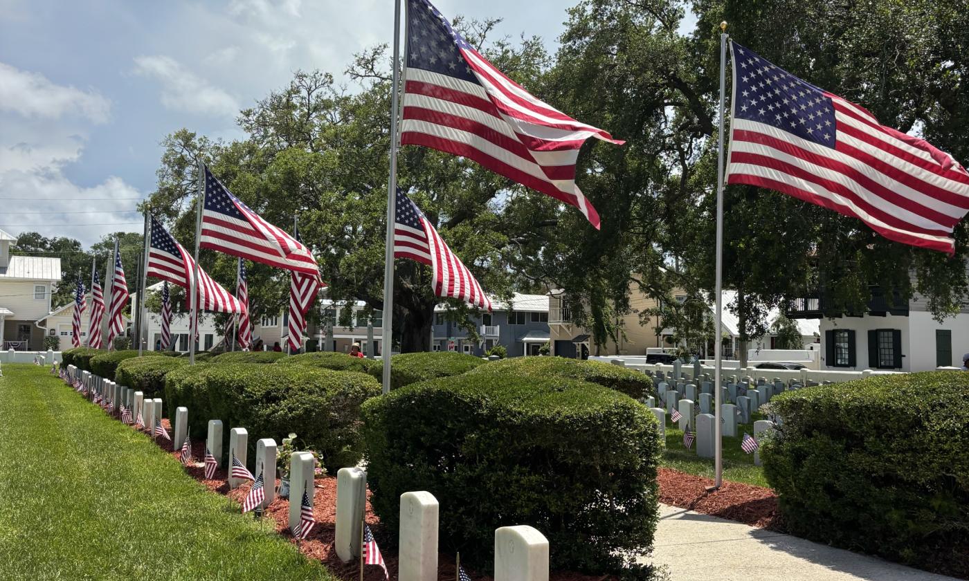 American flags flying and placed on graves