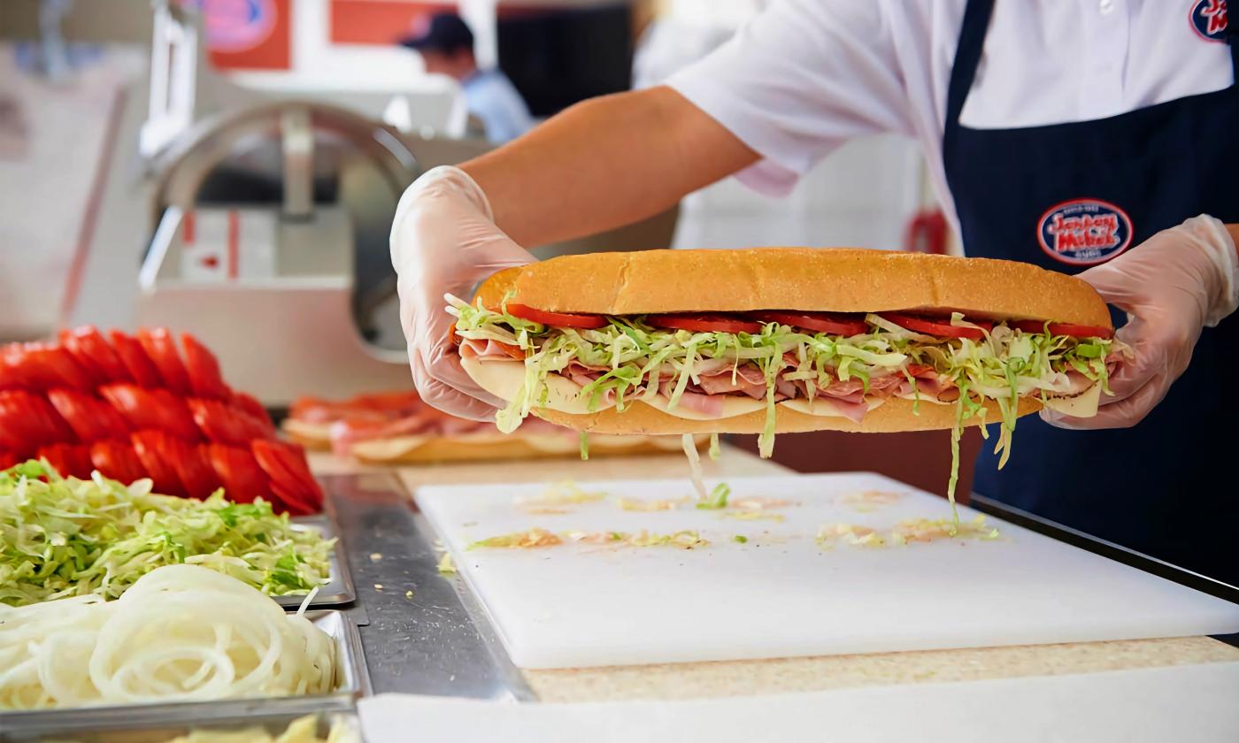 A worker making a sandwich
