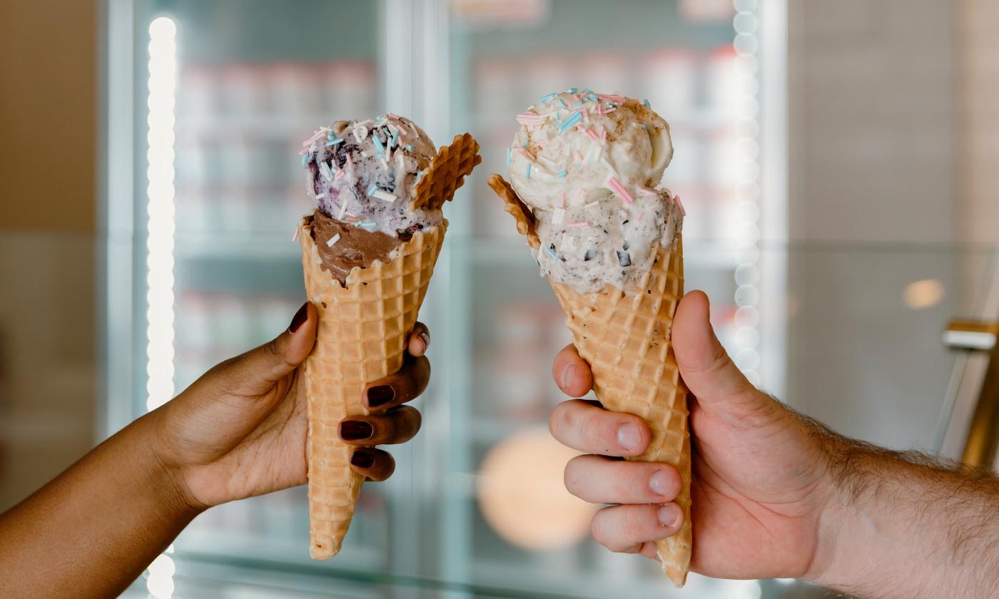 Ice cream cones being held up