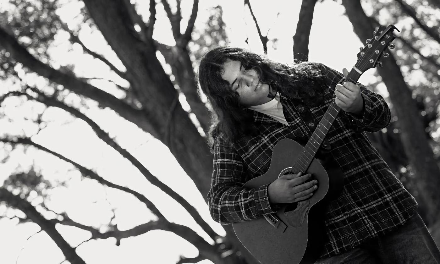 Musician Lane Drix in the winter under stark trees