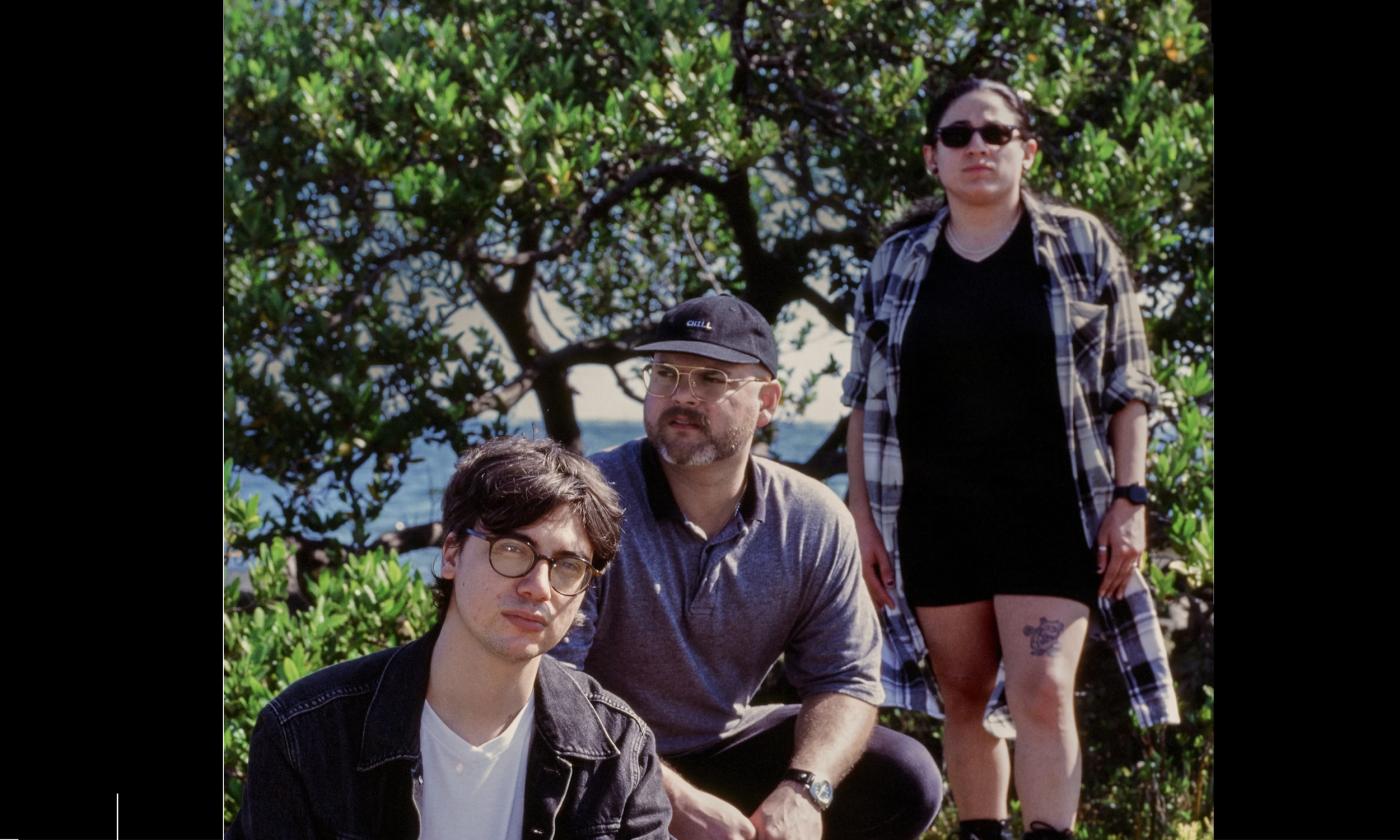 Three core members of the House of I outside among foliage