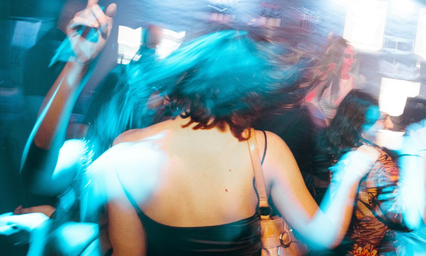 A group of men and women party at the club.