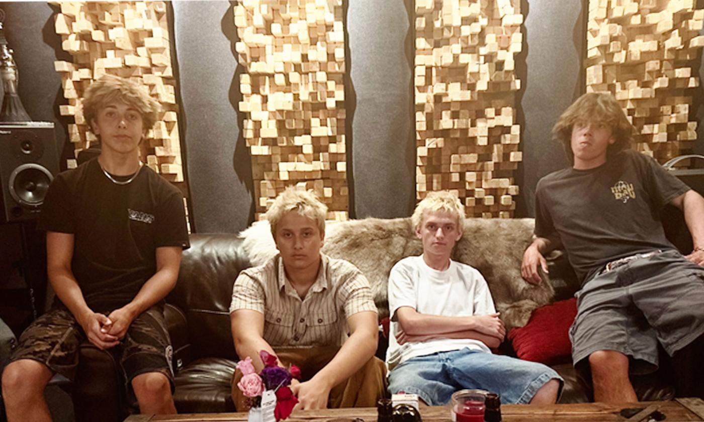 the band Pocket Thief slouched on a couch. 