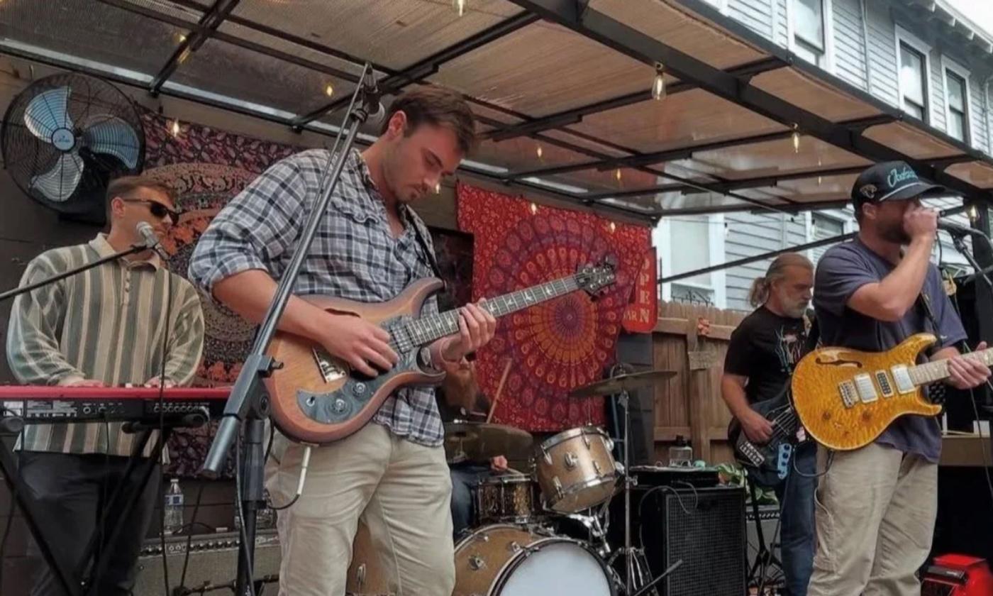 The band Three Leg Cat performing on stage