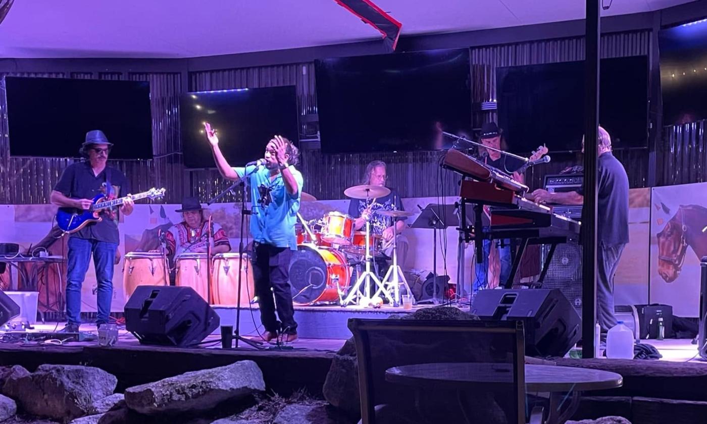Bandmates from Ultimate Santana performs live on stage.