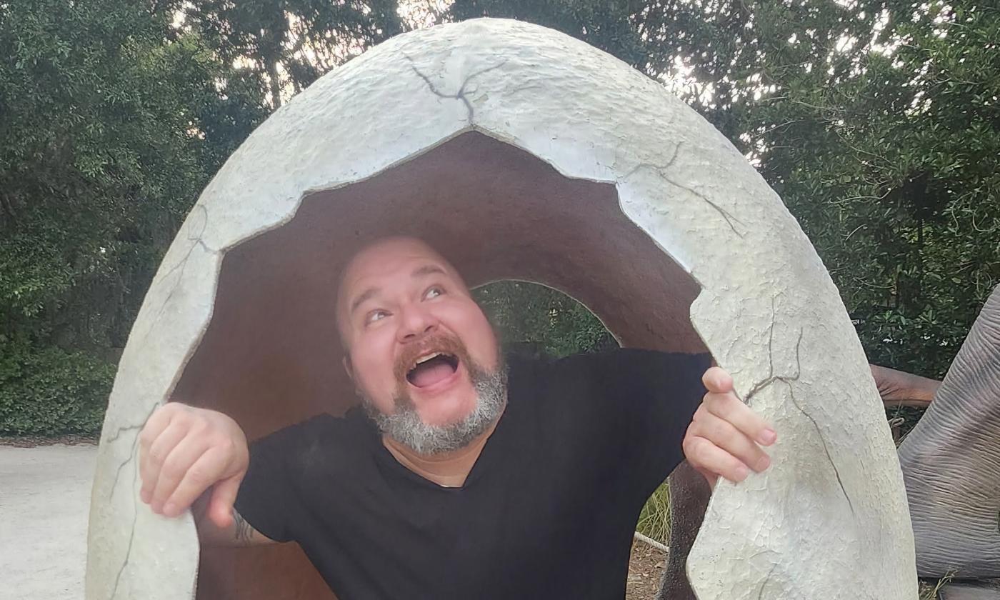 The comedian Marcus Crespo breaking out of a giant egg