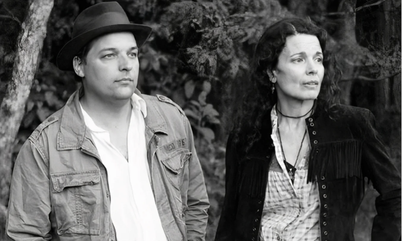 The bandmates of Donna the Buffalo turn their heads in unison, gazing intently at a distant object on the horizon.