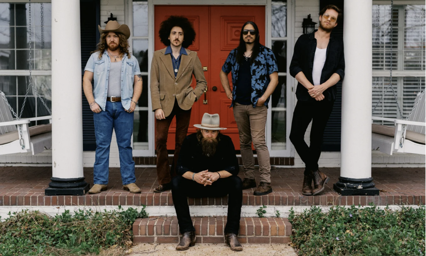 Bandmates from Robert Jon & The Wreck pose on a deck with white pillars.