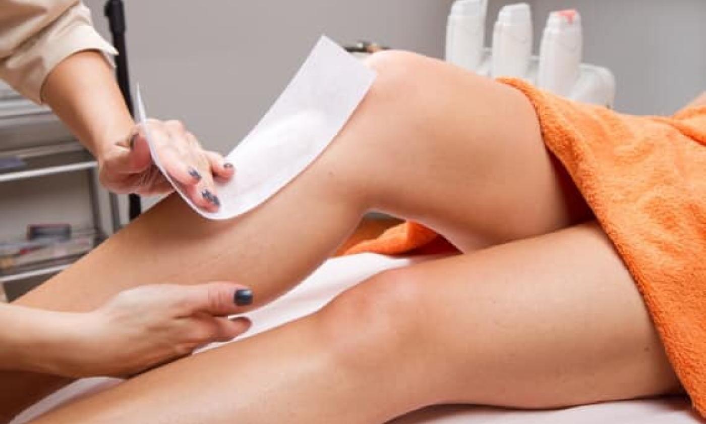 Women getting legs waxed 