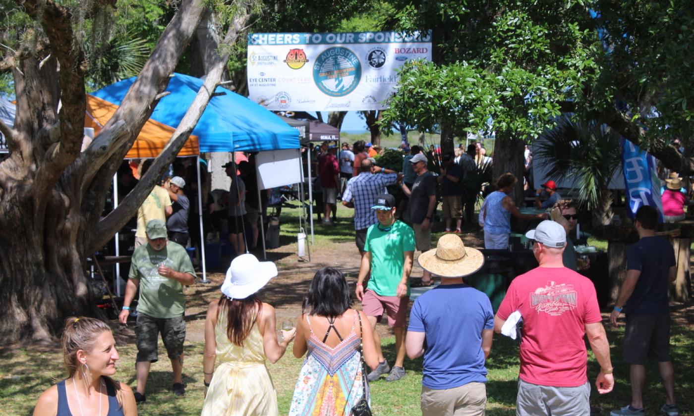 Happy craft brew enthusiasts enjoying the Brewers' Fest at the Fountain of Youth in St. Augustine.