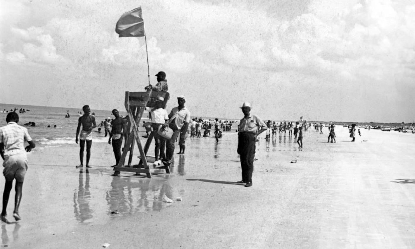 White peace officer, right, standing by the lifesaving station at Butler Beach - Anastasia Island, Florida. 1950 (circa). State Archives of Florida, Florida Memory. 