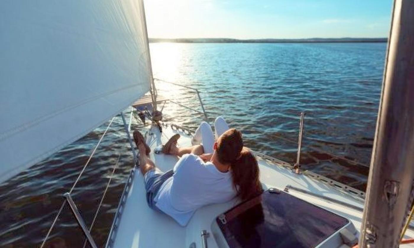 A couple enjoying a romantic sunset sail with St. Augustine Sailing in St. Augustine.