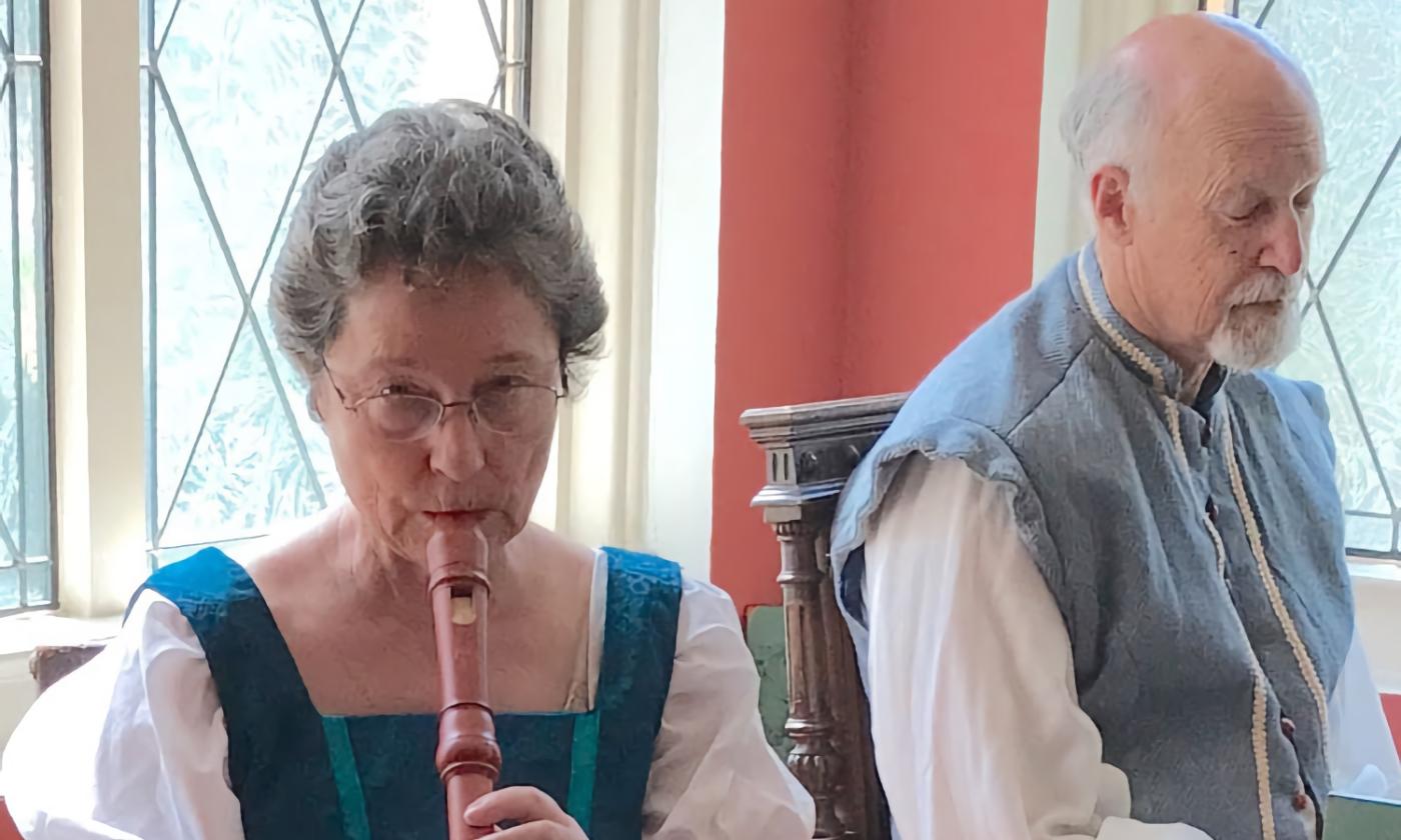 Patricia DeWitt on a recorder, accompanied by her husband, Peter DeWitt.