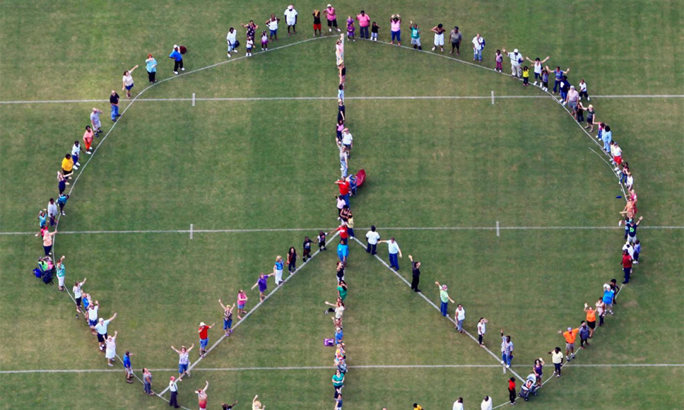 Pie in the Sky Community Alliance celebrates the International Day of Peace with a human peace sign. Photo by Walter Coker.