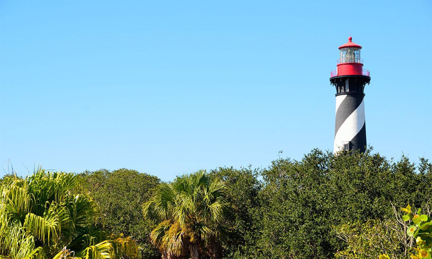 The St. Augsutine Lighthouse standing above the trees on Anastasia Island