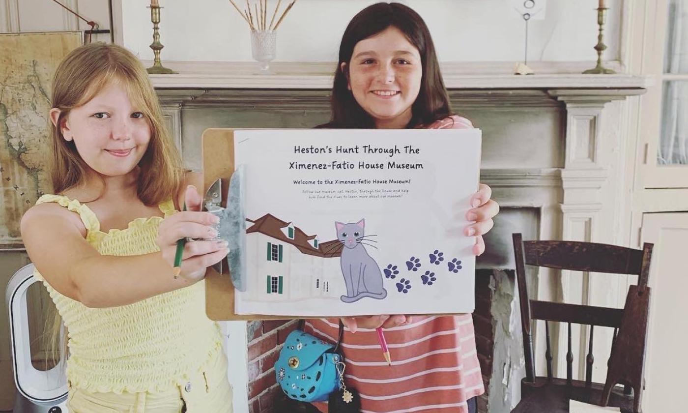Two girls exploring the Ximenez-Fatio House Museum during Fatio Fun Day in St. Augustine.
