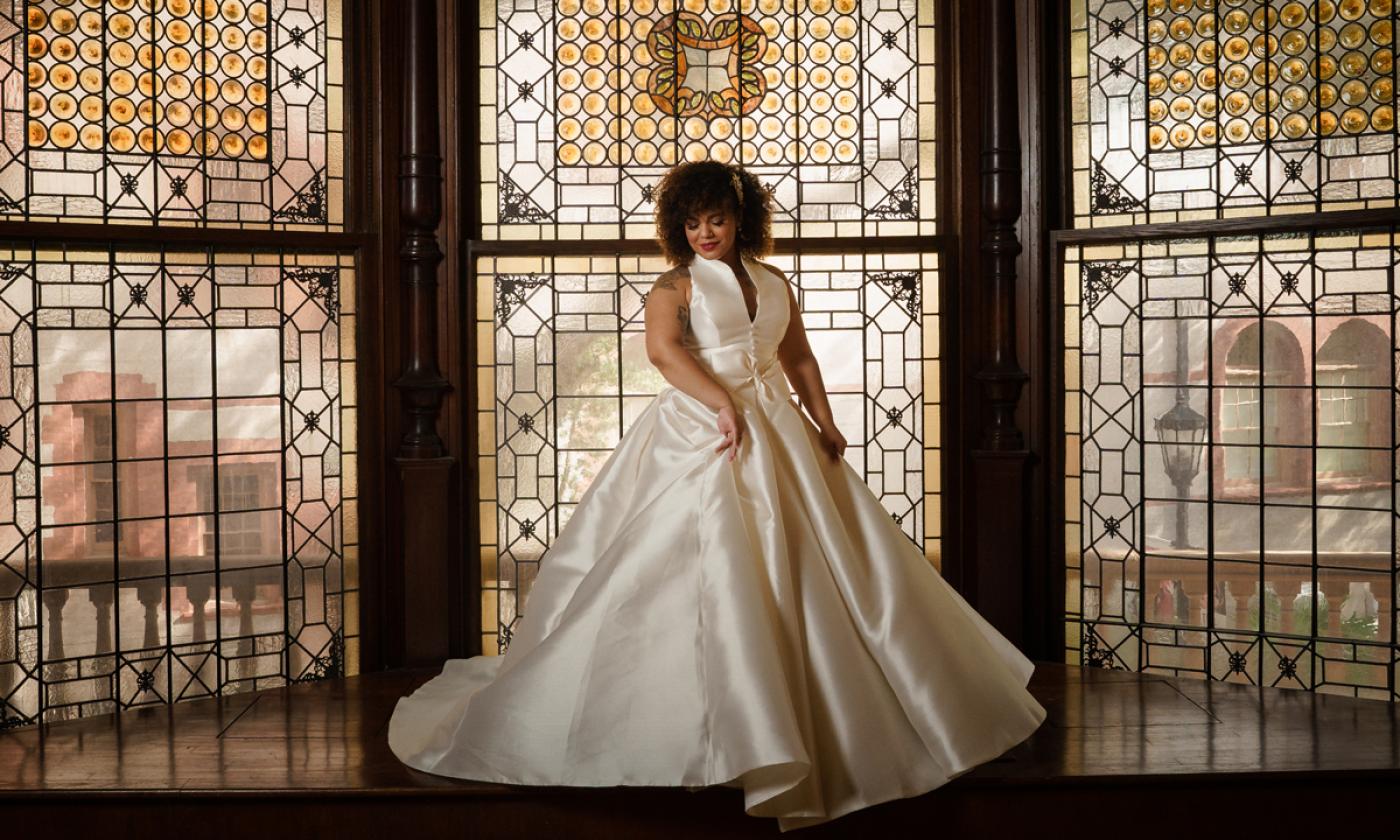 ride standing in front of a window in the Grand Ballroom of Flagler College in St. Augustine. Rob Futrell Photographer.