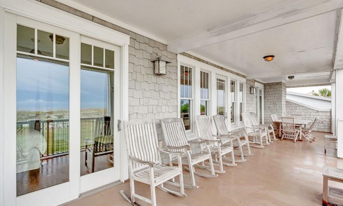 Guests can relax and rock on the southern-style deck at this Linda's Beach Rental in St. Augustine.