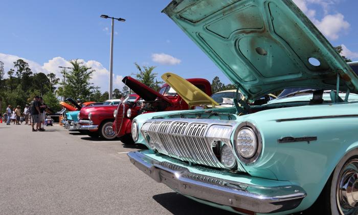 Antique Cars with their hoods raised at the Classic Car Museum's Monthly Cruise-In.
