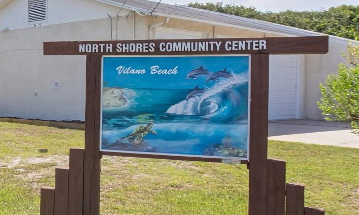 The sign at the North Shores Community Center in Vilano Beach features a painting of the ocean with dolphins