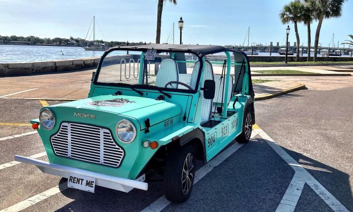 An aqua-colored Moke parked on the bayfront in St. Augustine