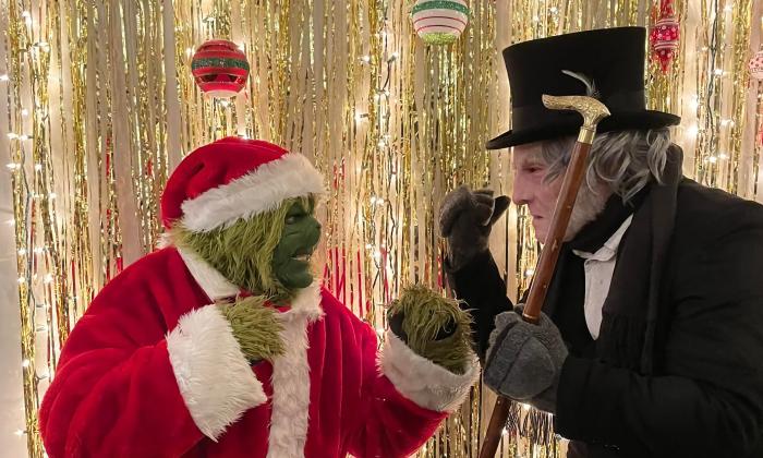 The Grinch and Scrooge facing each other with fists raised