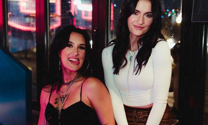 Presley and Taylor smile playfully for the camera. 