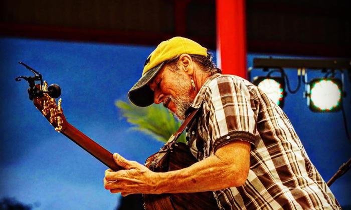 Musician Brian Smalley, playing guitar on stage