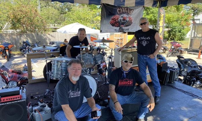 The Circus poses with their musical instruments on a stage at Colonial Oak Park in St. Augustine