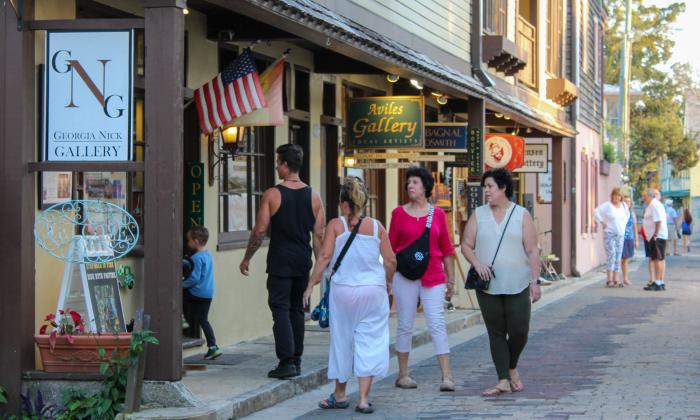 A group of visitors walking into the Georgia Nick Gallery during First Friday Art Walk in St. Augustine