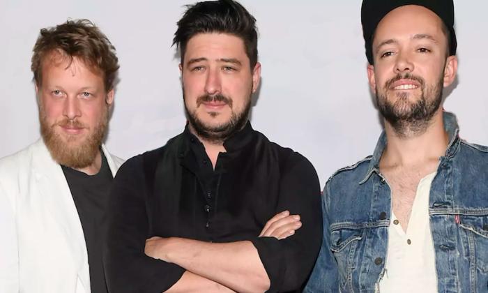 Image of three men posing for photo op, the music trio Mumford & Sons 