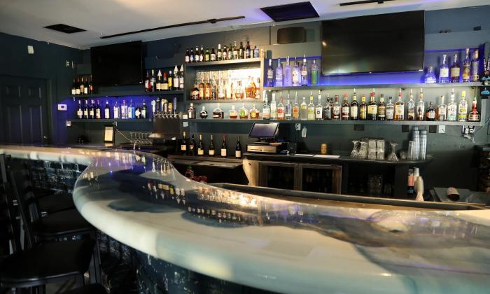The bar at the Beacon Listening room has a curved top and blue lighting