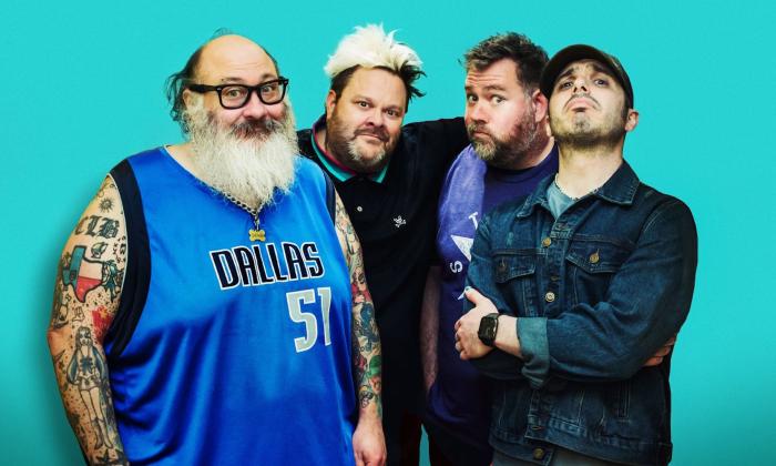 Bandmates from Bowling For Soup and Lit smile and pose in front of a teal background. 